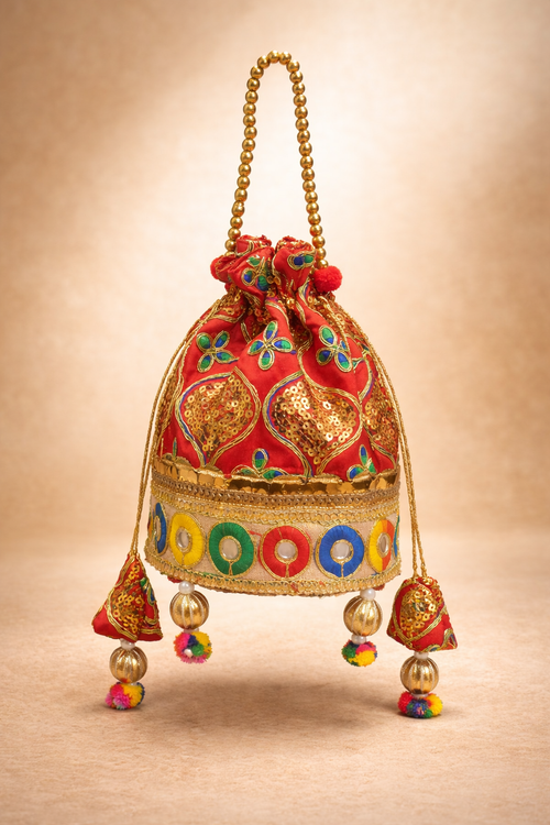 Close-up of Grand Heritage potli base showing intricate hand-crafted zari mirror work lace border